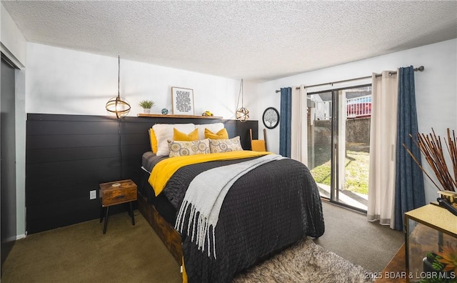 carpeted bedroom featuring a textured ceiling, multiple windows, and access to exterior