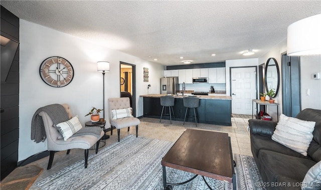 living room featuring recessed lighting, light tile patterned flooring, and a textured ceiling