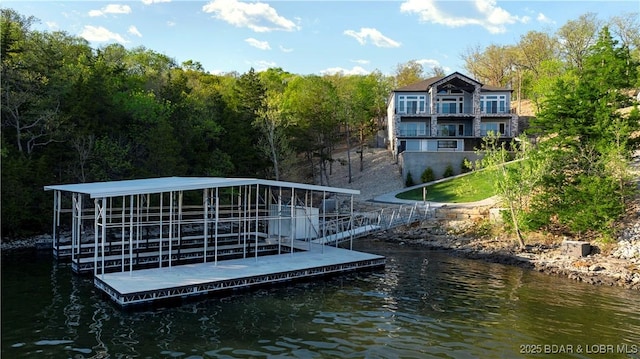 dock area featuring a wooded view and a water view