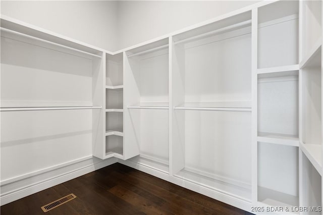 spacious closet featuring dark wood-style floors and visible vents