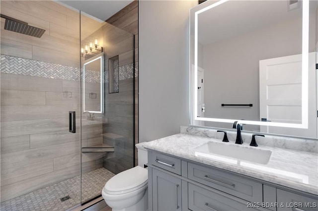 bathroom featuring a stall shower, visible vents, vanity, and toilet
