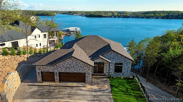 birds eye view of property with a water view