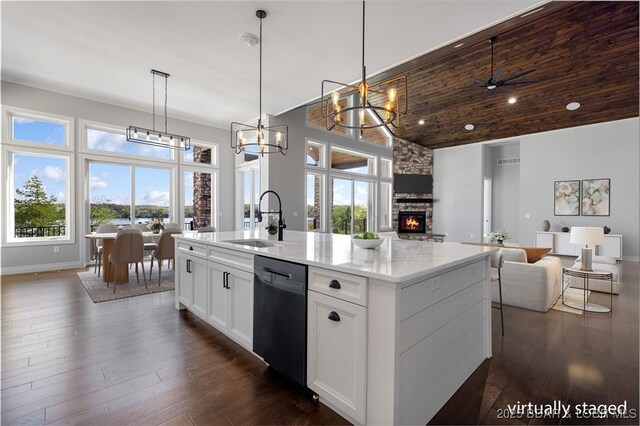 kitchen featuring high vaulted ceiling, a sink, open floor plan, a center island with sink, and dishwasher