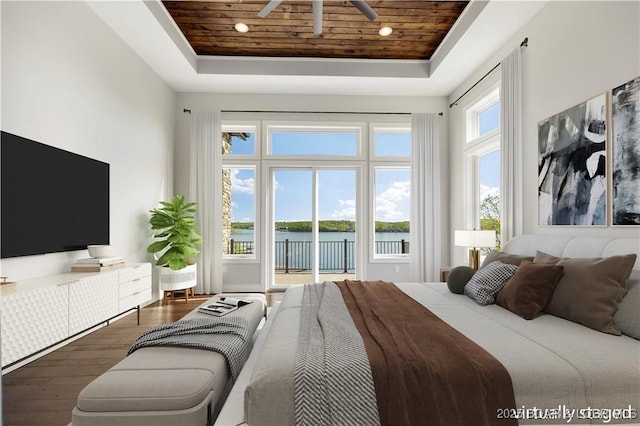 bedroom with wooden ceiling, a raised ceiling, access to outside, and hardwood / wood-style floors