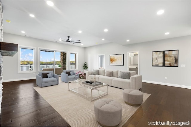 living room with baseboards, dark wood-type flooring, a ceiling fan, and recessed lighting