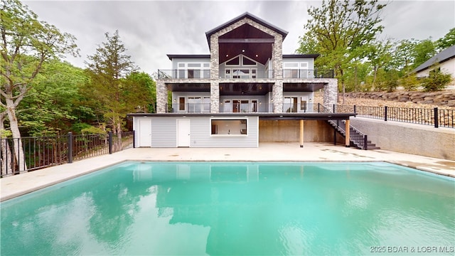 back of house featuring a fenced in pool, fence, a patio, stone siding, and stairway