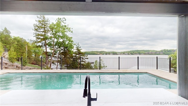 view of swimming pool featuring fence, a fenced in pool, and a patio area