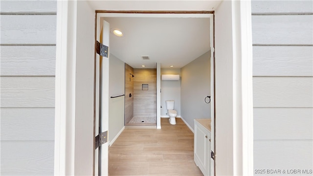bathroom with toilet, wood finished floors, visible vents, recessed lighting, and a stall shower