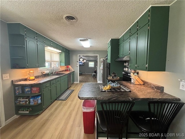 kitchen featuring open shelves, light wood-style flooring, fridge, and a sink
