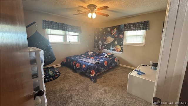 bedroom with a textured ceiling, ceiling fan, and carpet floors