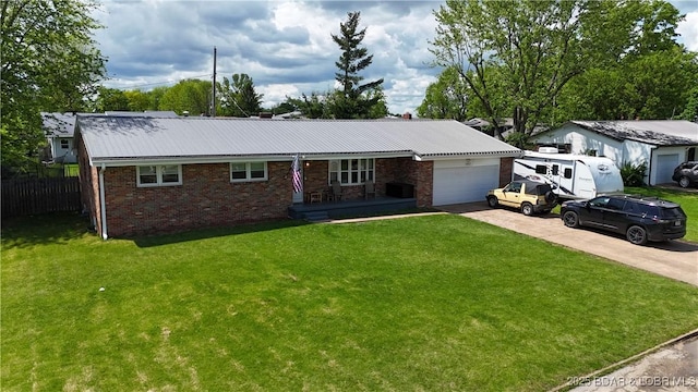 single story home featuring a front lawn, brick siding, driveway, and a garage