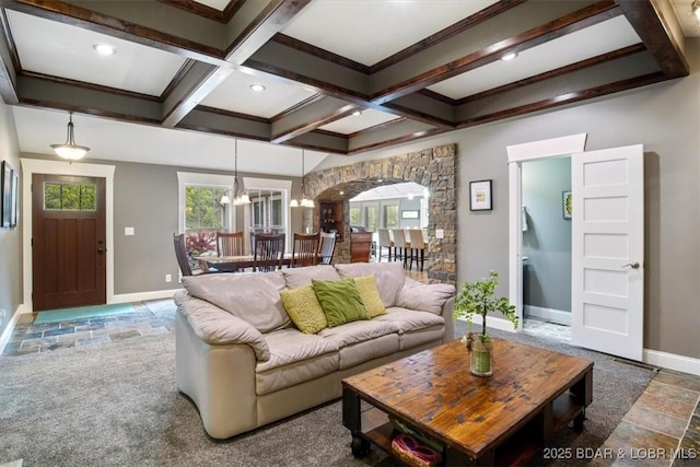 649 Nichol Rd, Edwards, MO 65326 - living room featuring coffered ceiling, baseboards, a chandelier, arched walkways, and beamed ceiling