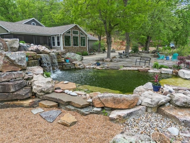 649 Nichol Rd, Edwards, MO 65326 - view of yard featuring a patio area, a sunroom, and a garden pond