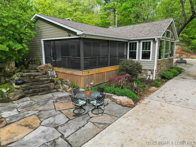 649 Nichol Rd, Edwards, MO 65326 - exterior space with a sunroom, a shingled roof, and a patio