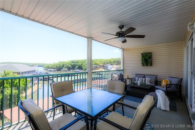 view of patio / terrace featuring an outdoor hangout area, outdoor dining space, a water view, and a ceiling fan