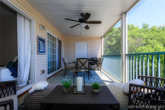 balcony featuring outdoor dining area and a ceiling fan