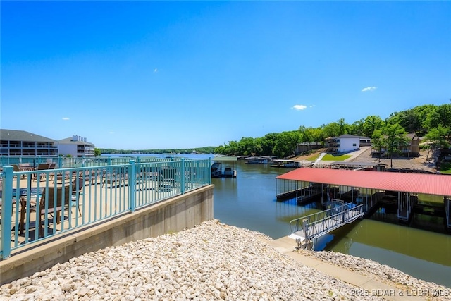view of dock with fence and a water view