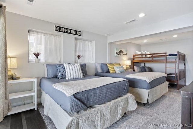 bedroom with visible vents, wood finished floors, and recessed lighting