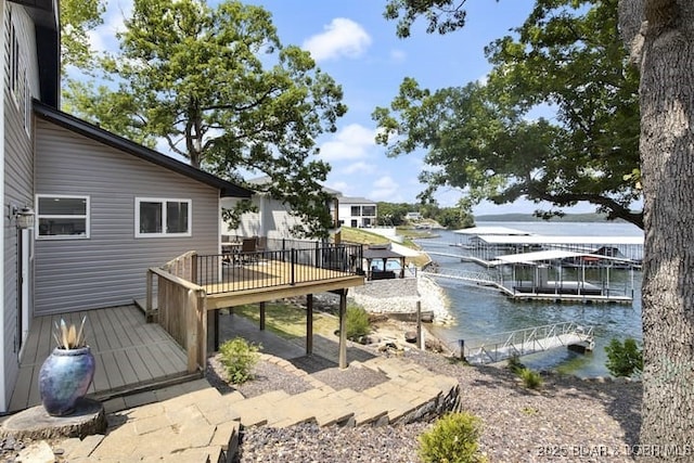view of dock with a deck with water view