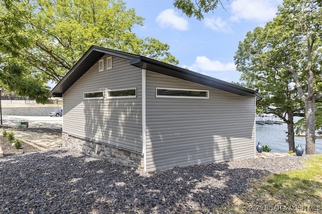 view of property exterior with a water view