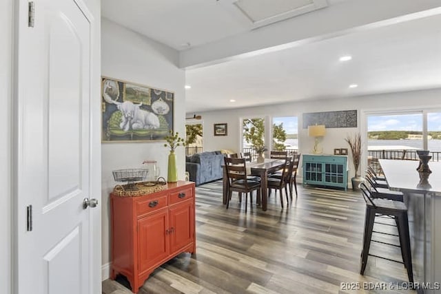 dining space featuring recessed lighting, plenty of natural light, and wood finished floors