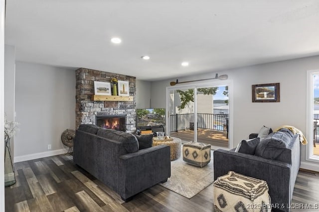 living room with dark wood-style flooring, a fireplace, baseboards, and recessed lighting