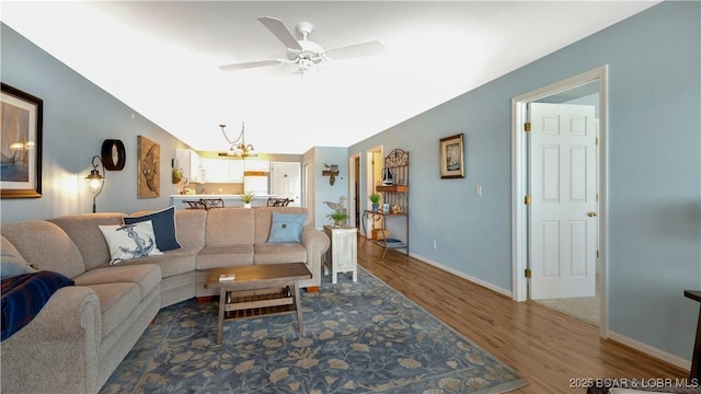 194 Park Place Ln Unit 3C, Kaiser, MO 65047 - living room with wood finished floors, a chandelier, a ceiling fan, and baseboards