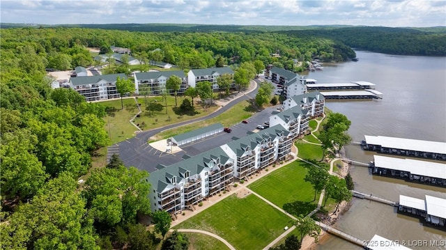 bird's eye view with a wooded view and a water view
