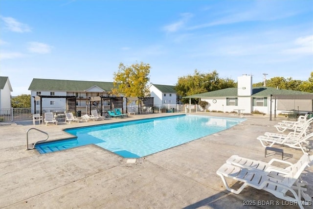 pool with fence and a patio