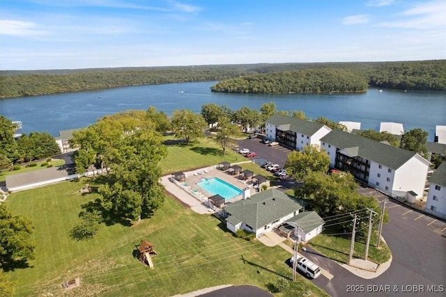 birds eye view of property with a wooded view and a water view