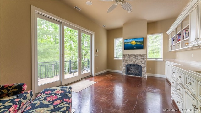 207 Buck Deer Ln, Camdenton, MO 65020 - living room featuring a tiled fireplace, visible vents, baseboards, and ceiling fan