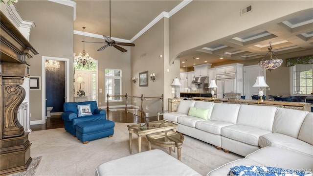 207 Buck Deer Ln, Camdenton, MO 65020 - living room featuring beamed ceiling, ornamental molding, visible vents, and a high ceiling