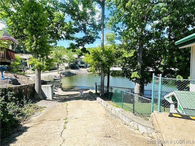 exterior space featuring fence and a dock
