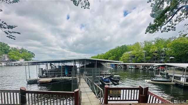 dock area featuring boat lift and a water view