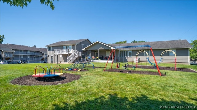 611 Lazy Days Rd Unit L5, Osage Beach, MO 65065 - rear view of property with a yard, stairs, and a playground