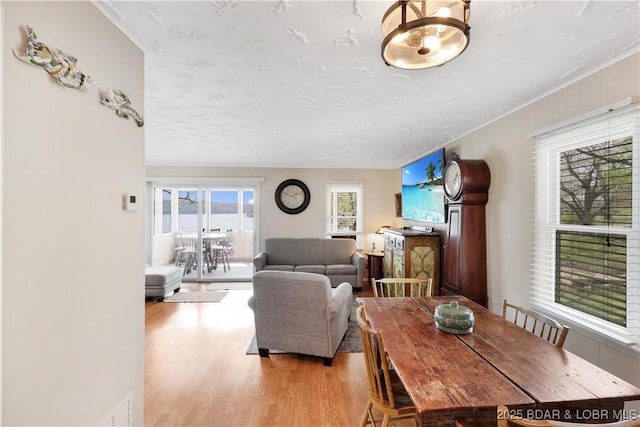 dining space featuring light wood-style flooring