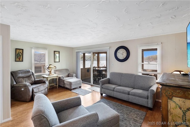 living area with healthy amount of natural light and wood finished floors