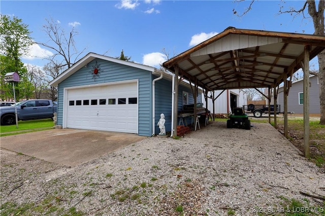 view of side of property featuring a detached garage and an outbuilding