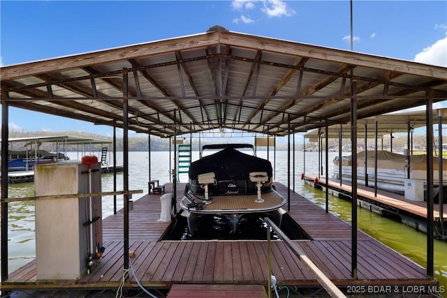 dock area with boat lift and a water view