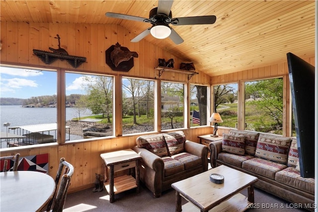 sunroom featuring lofted ceiling, wood walls, a water view, wooden ceiling, and carpet flooring