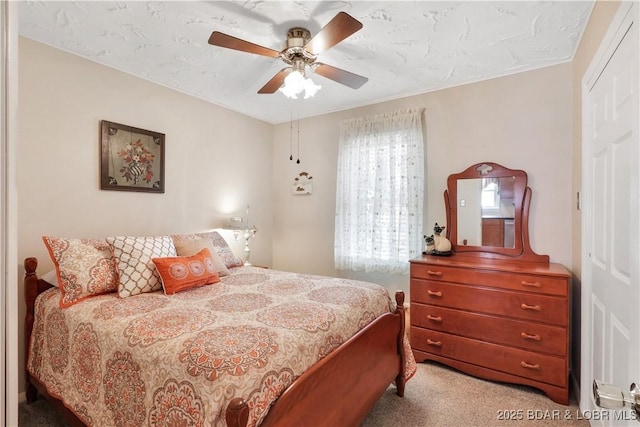 bedroom featuring light carpet, a closet, and a ceiling fan