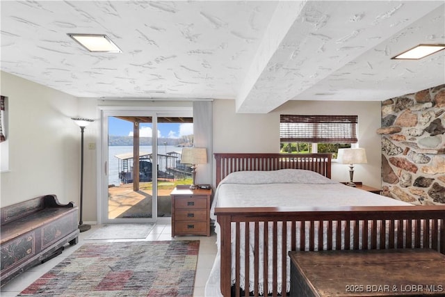bedroom with tile patterned flooring and access to exterior