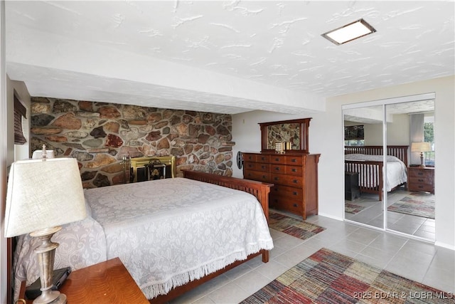 tiled bedroom with a closet