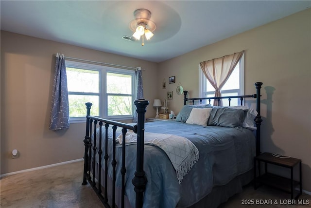 carpeted bedroom with baseboards, ceiling fan, and visible vents