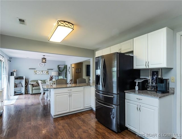 kitchen featuring black refrigerator with ice dispenser, visible vents, open floor plan, a peninsula, and white cabinets