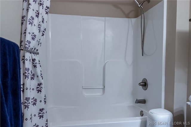 bathroom with toilet and shower / bath combo