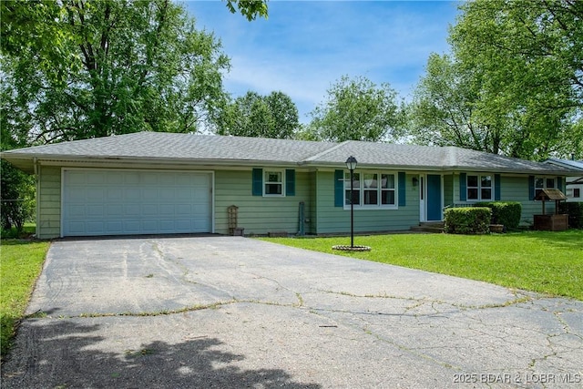 ranch-style house featuring aphalt driveway, an attached garage, and a front yard