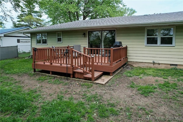 back of property featuring a shingled roof, fence, and a wooden deck