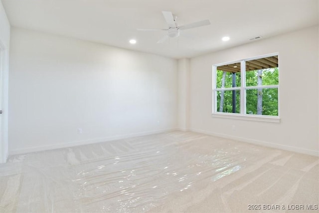 spare room with baseboards, recessed lighting, and carpet floors