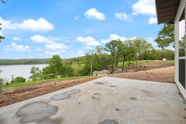 view of yard with a patio and a water view